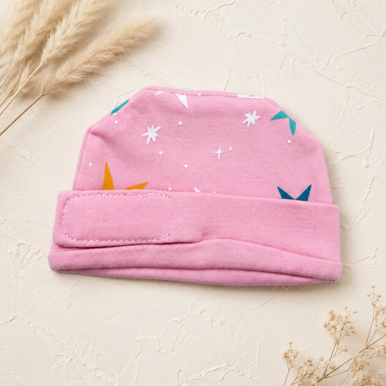 Pink star-print preemie/NICU cap, front view