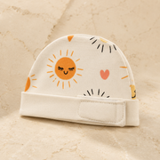 White sun-print preemie/NICU cap, front view