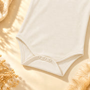 Off White | ZB Baby Basic Bodysuit – three snaps detail angle luxury gold