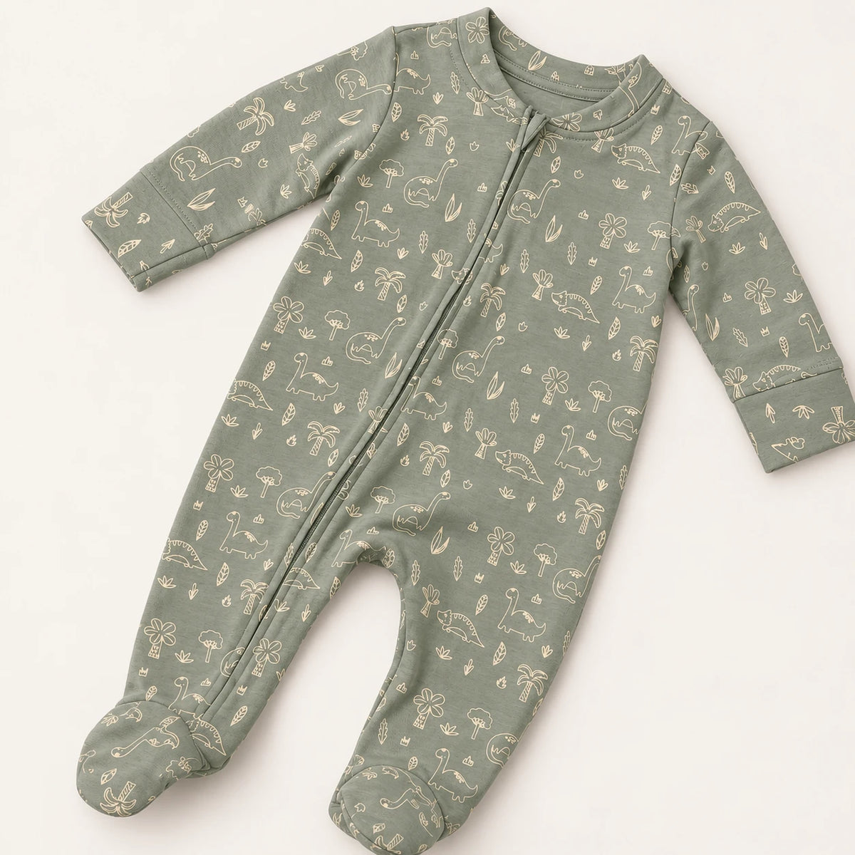 Little Dino | ZB green dinosaur-print footed zipper romper, angled view