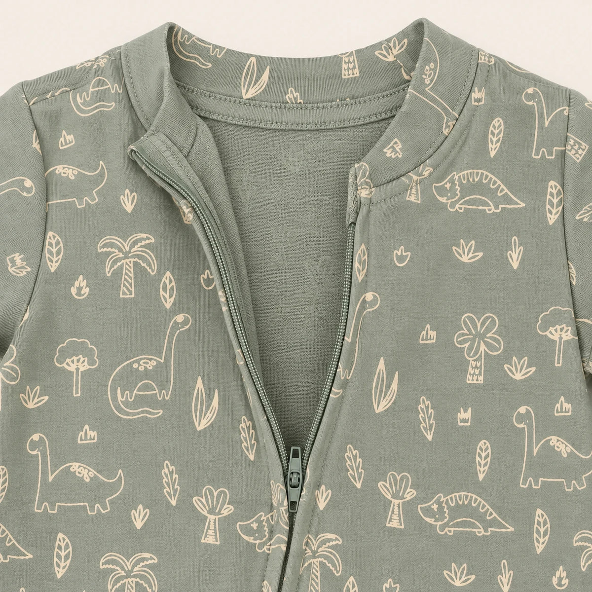 Little Dino | ZB green dinosaur-print footed zipper romper, neckline and zipper detail