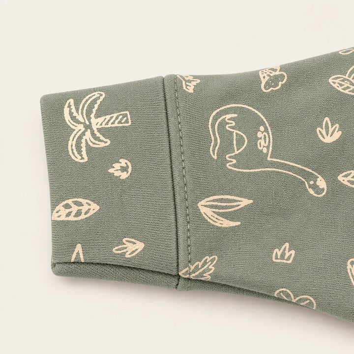 Little Dino | ZB green dinosaur-print footed zipper romper, sleeve and print detail