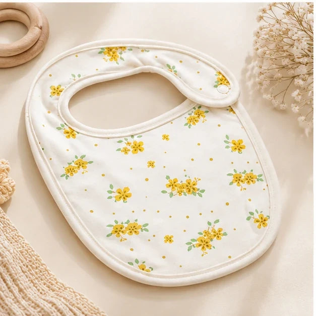 Tiny Blossom | Baby bib angled view on premium neutral background