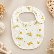 Tiny Blossom | Baby bib front view on premium neutral background